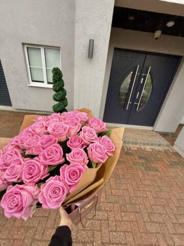 Fifty pink roses bouquet wrapped in a premium craft paper, Luxury pink rose delivery in London.